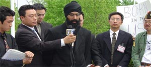 Photo 1. UNITED SIKHS' Manwinder Singh<br>Addressing the Media