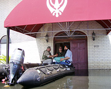 UNITED SIKHS rescue squad with Sri Guru Granth Sahib on the Zodiac Boat