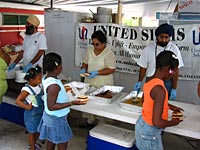 UNITED SIKHS volunteer selving hot meals at shelter home.