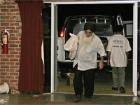 Photo of UNITED SIKHS volunteers carrying supplies into Ward 7.